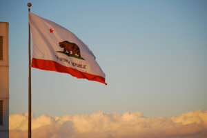 California state flag flies over the clouds