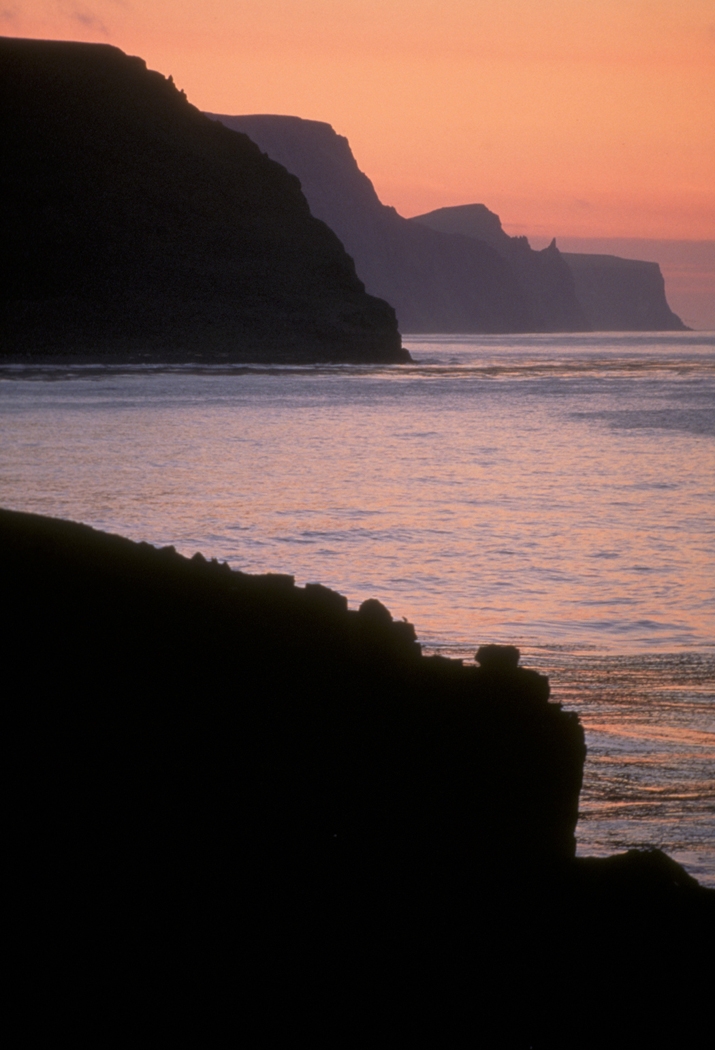 A sunset adds drama to the high bluffs of St. George Island, one of the Pribilof Islands in the Alaska Maritime National Wildlife Refuge Credit: Dean Kildaw/USFWS