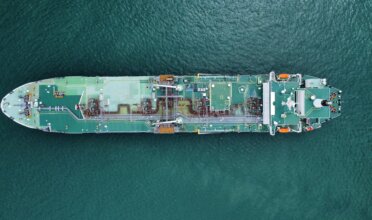 Shipping tanker sails on the ocean.